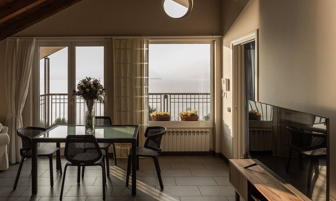 Reno House | Holiday Home 'Attico Borromea' with Lake View, Shared Pool and Wi-Fi