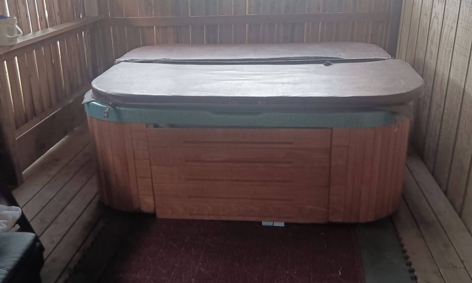 Sand Lake Apartment | Hot Tub and King bed with 3 other beds