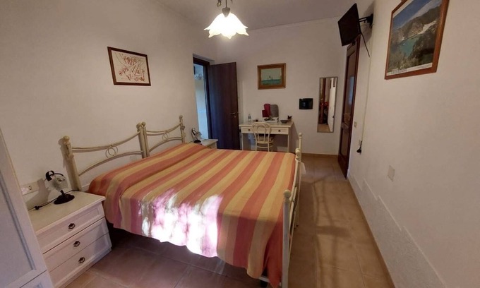 Iglesias Historic Centre Apartment | House The Ancient Olive Tree, nestled in a centuries-old olive grove with a large garden around it.