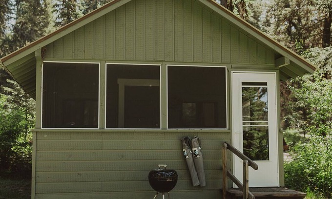Seeley Lake Cabin | Huckleberry Cabin at Tamaracks Resort with a lake facing furnished screen porch.