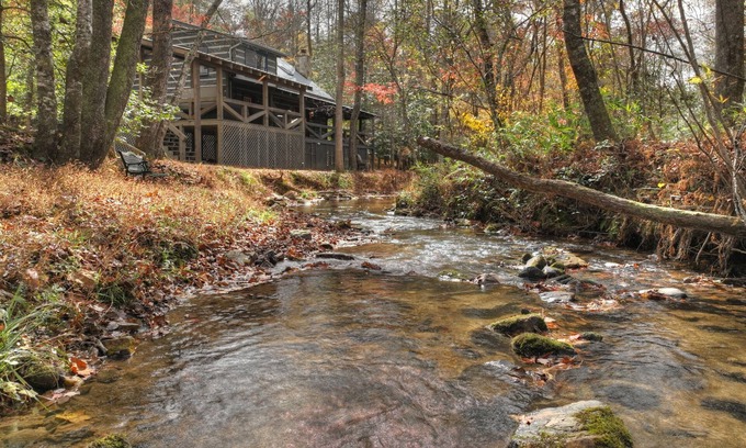 Dial Cabin | Indulge in "Just One More Night", a pet-friendly creekfront retreat boasting a spacious outdoor deck, hot tub, firepit, and WiFi