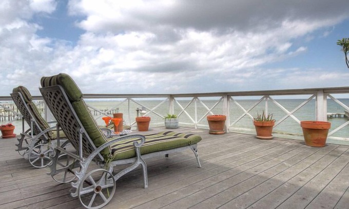 Bacliff Cottage | La Petit Maison, is a waterfront two-story cottage near Kemah,TX