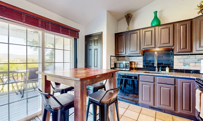 Holiday Island Condo | Lake view condo with fireplace, firepit, deck & central AC