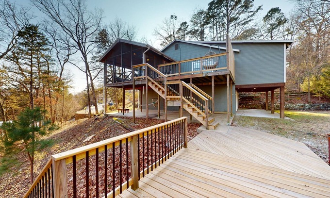 Powell House | Lakefront retreat with screened sunroom, wood stove, multiple decks, & AC