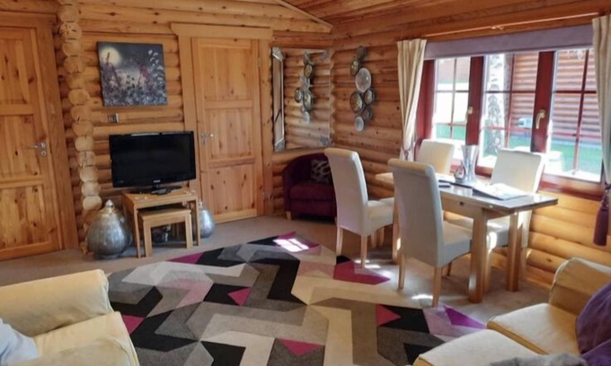 Morpeth Cabin | Lakeside Log Cabin with hot tub overlooking the water.