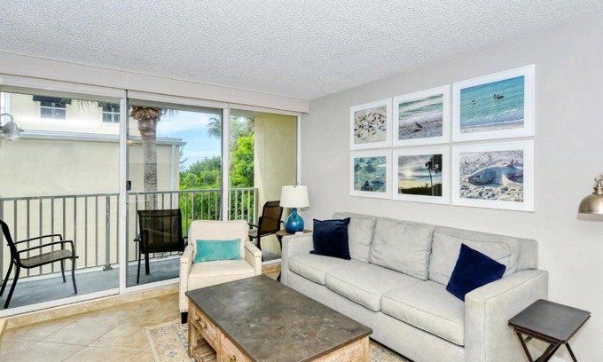 Longboat Key Apartment | LaPlaya 202E Catch the gentle Gulf breezes on your private balcony beneath the swaying palms