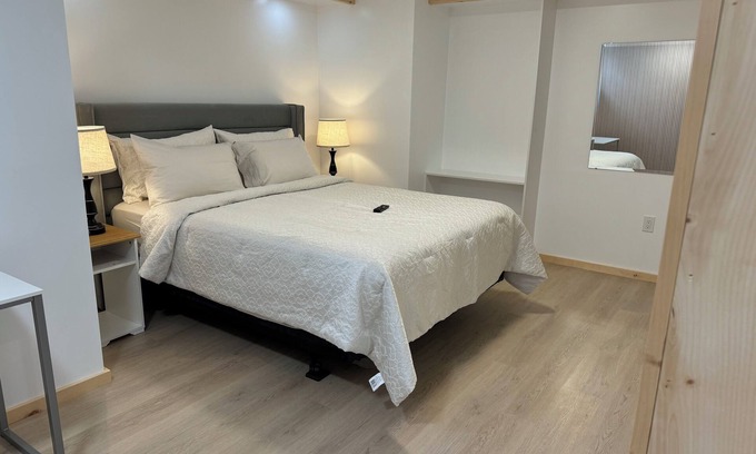Ottawa Division House | Large bedroom with private bathroom and workspace.