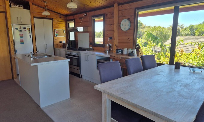 New Plymouth House | Lockwood holiday house, nestled among lush trees.
