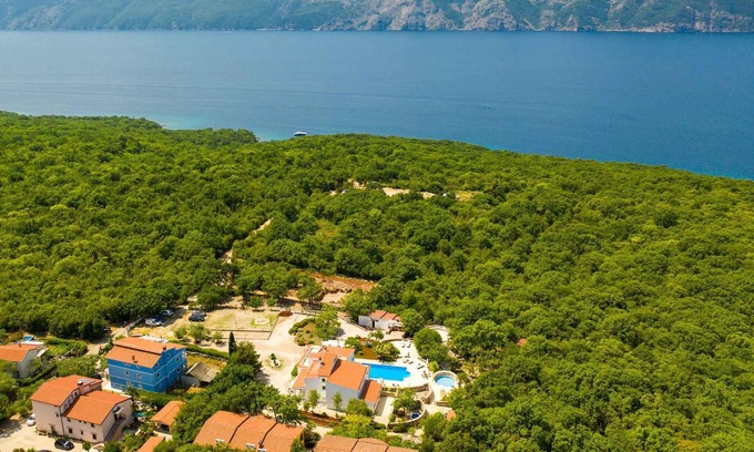 Brzac Apartment | Lotus Resort vacation apartment with swimming pools and garden as well as children's playground and parking lot surrounded by greenery and forest