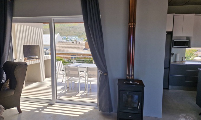 Sandbaai House | Luxury 2 Bed apartment boasting a rooftop terrace, with mountain & sea views.