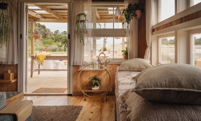 Pouto Cottage | Luxury eco-design waterfront fishing Batch with guests' vegetable garden.