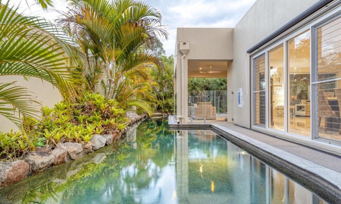 Pelican Waters House | Luxury resort style villa pool by Custom Bnb Hosting
