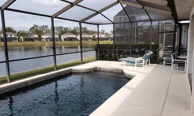 Sunset Lakes Villa | Luxury villa Near Disney Gated Lake View Heated Pool w/sunset & home office