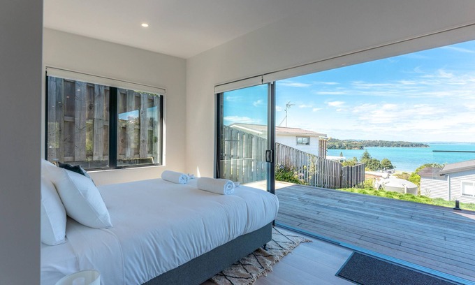 Surfdale Cottage | Marama Cottages - Luna Cottage - Located in the heart of Surfdale with outstanding views over the water this brand new 2 bedroom apartment is perfect for family holidays on Waiheke – walking distance to local beaches, off street parking for up to 2 v