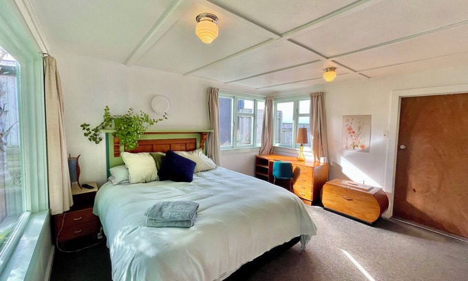 Castlecliff House | Mid-Century Beach Front Bach with beach access 2 doors down and superb views
