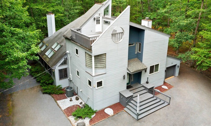 Bushkill House | Modern Creek-front House with Volleyball court in the backyard.