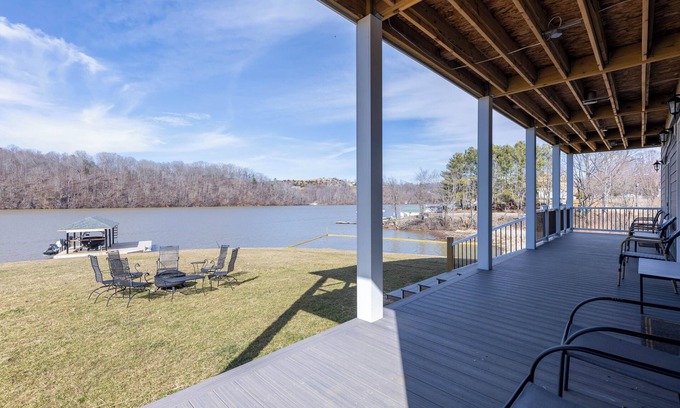Ingles House | Modern lakefront home with wraparound decks, firepit, and stunning water views on both levels.