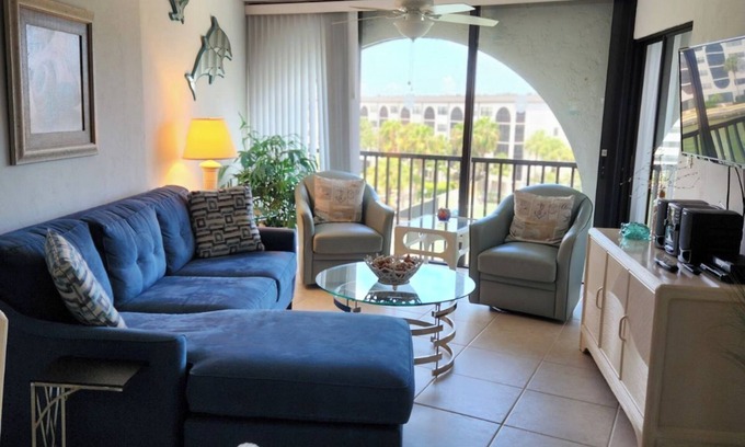 Marco Island Condo | Modern top floor with a beautiful view of the bay, pool, waterfront restaurant