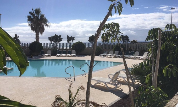 El Medano Apartment | Modern two floor apartment right by the beach with pool, patio and paddle court