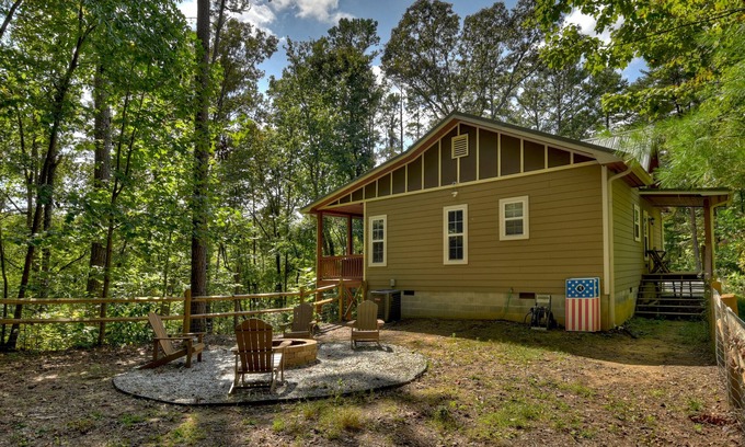 Ellijay Cabin | Mountain Livin' beckons with pet-friendly charm, complete with a fenced yard, soothing hot tub, crackling firepit, and reliable WiFi
