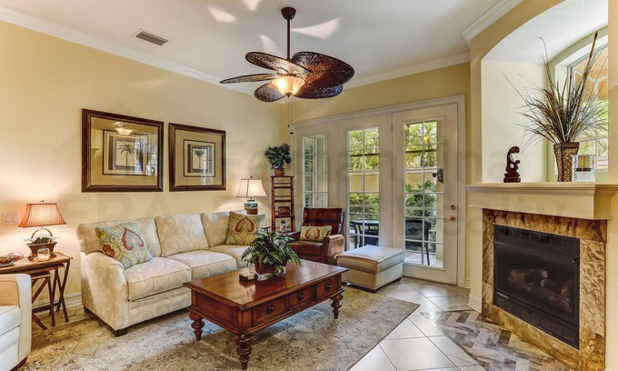 American Beach Condo | Nestled in a sancutary of beautiful trees in gated Villas at Summer Beach. Ground Floor unit.