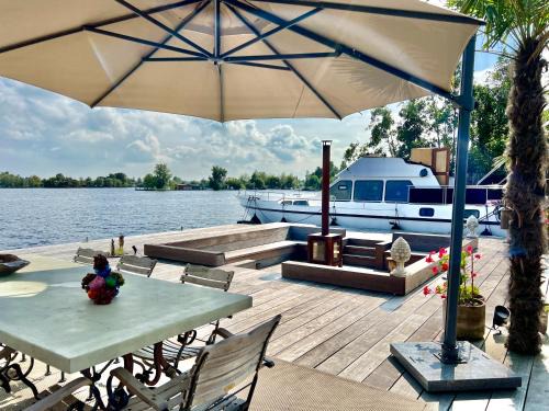 Baambrugse Zuwe Boat Rental | NEW - LITTLE IBIZA, on a lake near Amsterdam, with HOT TUB!