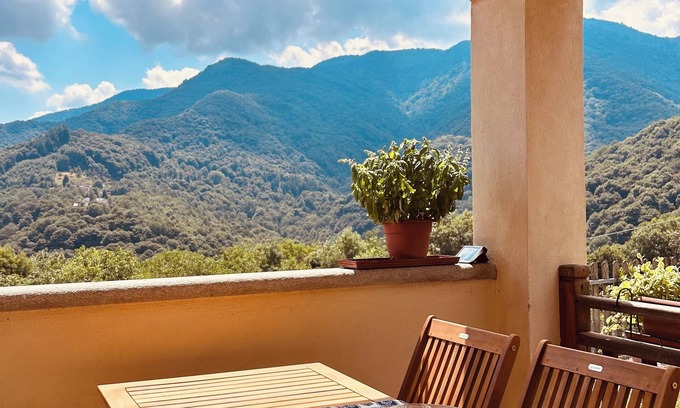 Sanfront House | Panoramic two-story dwelling with private garden, surrounded by green woods.