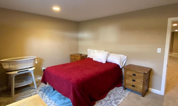 Maxwell House | Private basement bedroom with private bathroom, kitchen, and living room with large screen television