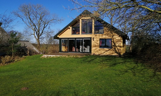 Gunneby House | Quaint, modern log cabin with barrel sauna, panoramic windows, Schlei view.