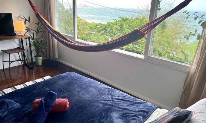 Vidigal Apartment | Relax and watch the sunrise across the ocean from your hammock. Views of Ipanema across the water