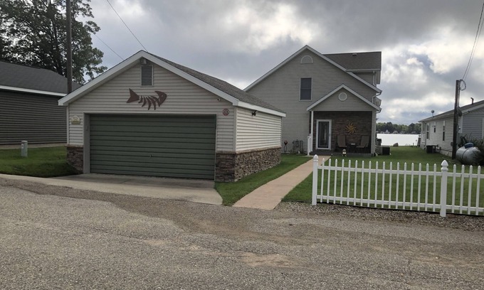 Lake House | Relax at the outdoor firepit or hot tub overlooking all-sports Eight Point Lake!