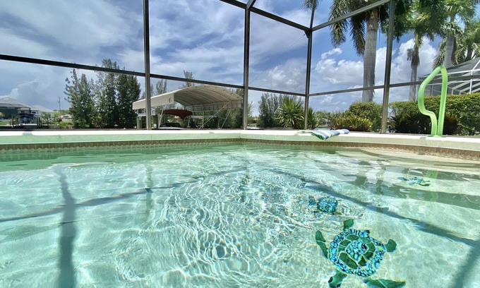 Burnt Store House | Relax! Canal Home, Sunsets, Heated Pool, Lanai with TV, Boat Dock, Gulf Access