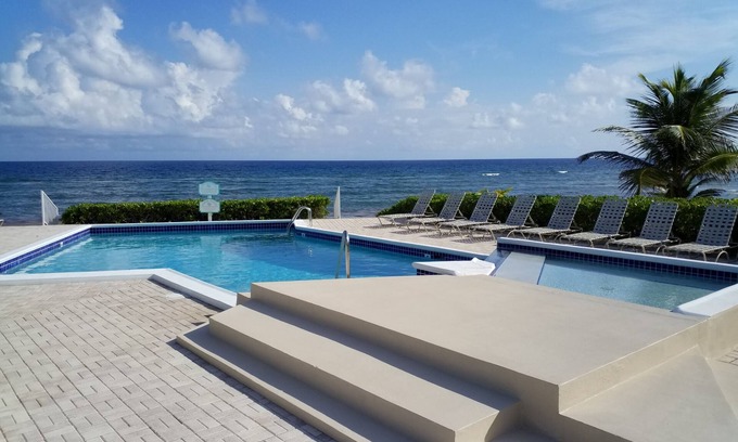 North Side Condo | Relax in Cayman Casual style. Modern convenience in a quiet beachfront setting.