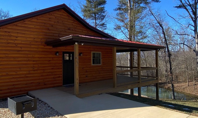 Stanley Cabin | Relax in our secluded hot tub overlooking the pond with a glass of wine