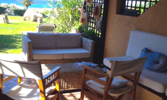 Golfo di Marinella Apartment | Relaxing beachfront apartment with spacious veranda, pool, a/c, parking