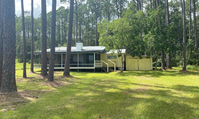 Carrabelle Cottage | Remodeled historic cottage with a peek of the Gulf of Mexico.
