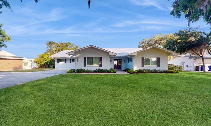 Lake Placid House | Renovated lakefront retreat with screened pool, private dock, patio, grill & W/D