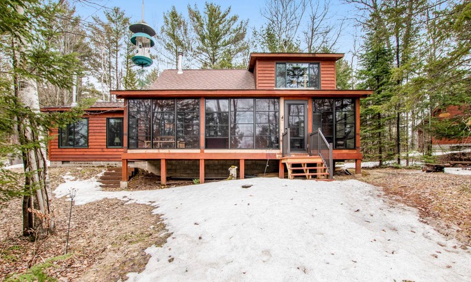 Lac du Flambeau Cabin | Riverfront vacation home with a dock, wood stove, full kitchen, & firepit