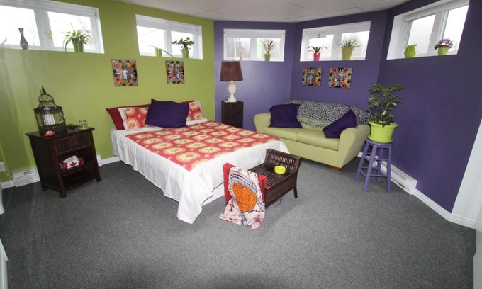 Notre-Dame-des-Monts House | Room in Guest room - Gandhi Very large room decorated in Indian style, office space and sofa