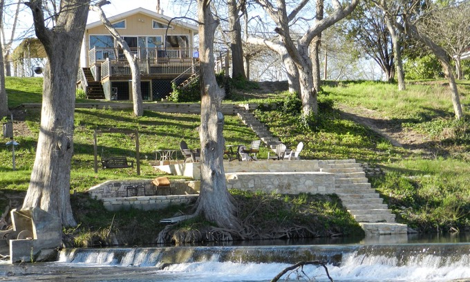 New Braunfels House | Scenic riverfront home on quiet stretch of Guadalupe - waterfall by huge front porch