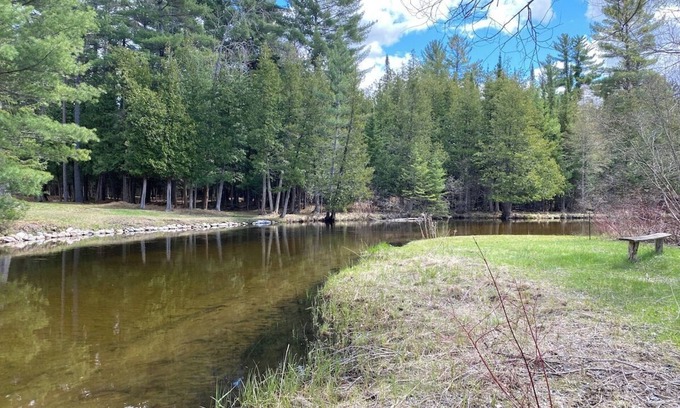 Grayling House | Secluded Riverfront Home in Grayling