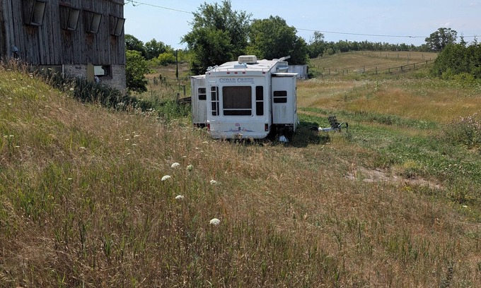 Asphodel-Norwood House | Serenity Lane Farm Stay: a trailer next to a barn full of farm animals