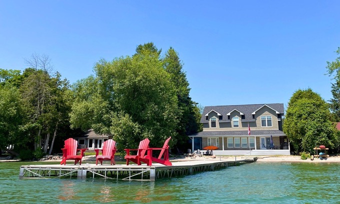 Big Bay Point Cottage | Shallow Beach Lakefront Cottage perfect with Kayak, Firepit, BBQ + Playground