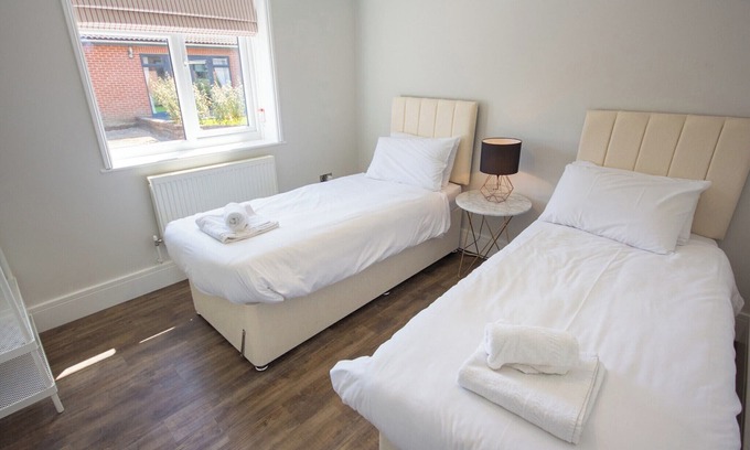 Rookley Cottage | Single-storey stylish open-plan living with French doors onto a deck and hedged lawn.