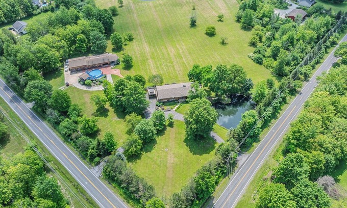 Painesville Cabin | Spacious 5-bedroom lodge on 35 acres with pool house, pool, 2 ponds, waterfall!