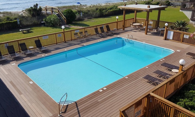 Wilmington Beach Condo | Spacious condo with large deck to view the beautiful ocean just a few feet away.