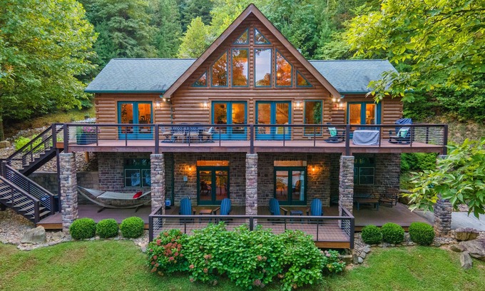 Big Creek Cabin | Spacious waterfront property with deck, hot tub, fireplace, & central AC
