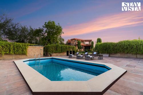 Dwarka Villa | StayVista at The Cityscape with Lawn & Pool