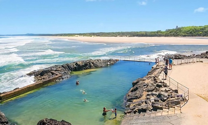 Sawtell House | Step out onto the sunny balcony of Peninsula - a spacious beachside home with superb ocean views.