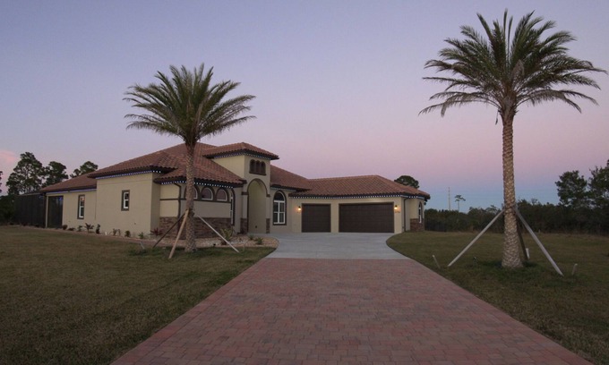 Grant-Valkaria House | Stunning Mediterranean-style vacation home w/ fabulous spillover hot tub/pool!